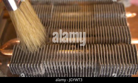 Notebook cooling system cleaning with a brush during service maintenance. Stock Photo
