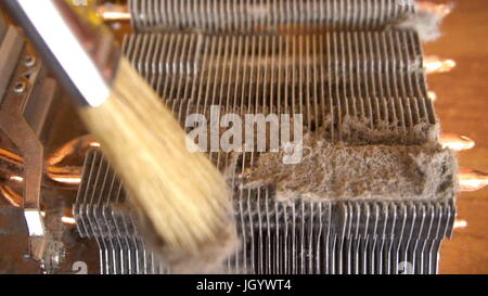 Notebook cooling system cleaning with a brush during service maintenance. Stock Photo