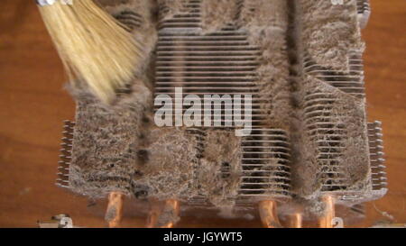 Notebook cooling system cleaning with a brush during service maintenance. Stock Photo