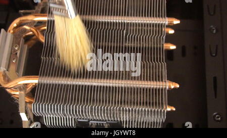Notebook cooling system cleaning with a brush during service maintenance. Stock Photo
