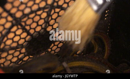 Notebook cooling system cleaning with a brush during service maintenance. Stock Photo