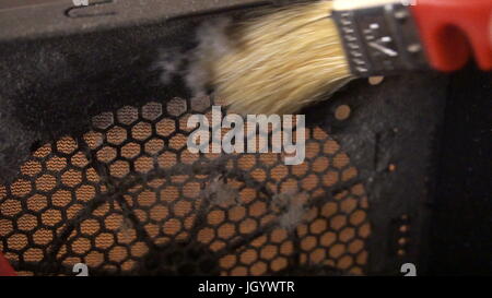 Notebook cooling system cleaning with a brush during service maintenance. Stock Photo