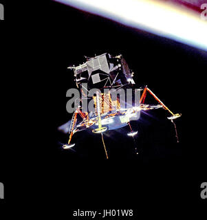 The Apollo 11 Lunar Module (LM) 'Eagle', in a landing configuration is photographed in lunar orbit from the Command and Service Modules (CSM) 'Columbia'. Inside the LM were Commander, Neil A. Armstrong, and Lunar Module Pilot Edwin E. 'Buzz' Aldrin Jr. The long 'rod-like' protrusions under the landing pods are lunar surface sensing probes. Upon contact with the lunar surface, the probes send a signal to the crew to shut down the descent engine. Stock Photo