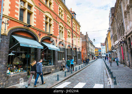 People walking on a cobbled street (Rue de la Monnaie) in Lille, France Stock Photo