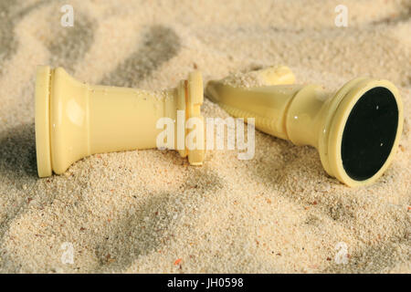 Chess pieces in a sand dune Stock Photo