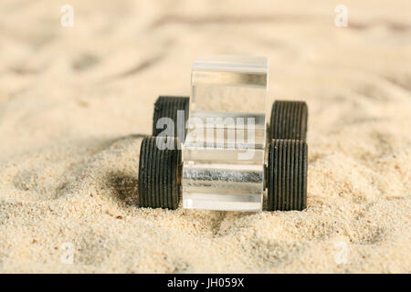 Transparent Methacrylate toy car in the sand Stock Photo