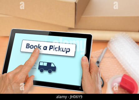 Booking a courier online with a collection of packaging materials and boxes Stock Photo