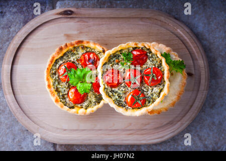 Plate of Mini quiche on a white background filled with vegetables with ...