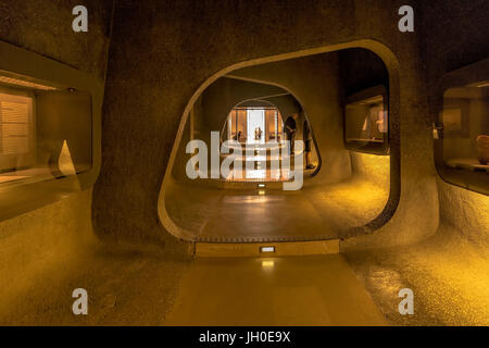 View into a dark cave-like passage with exhibits towards the entrance area of the Israel Museum in Jerusalem, Israel, famous for the Dead Sea Scrolls. Stock Photo