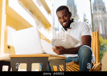Industrious optimistic guy analyzing data Stock Photo