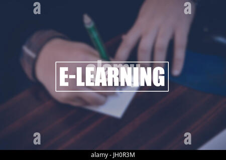 E-learning with blurring business man hand writing a note background,internet education concept Stock Photo