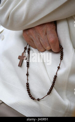 Hand-carved Roman Catholic rosary beads. Woman praying The Mystery of the Holy Rosary. France. Stock Photo