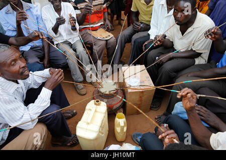 Ugandan villagers drinking home-brewed beer. Uganda. Stock Photo
