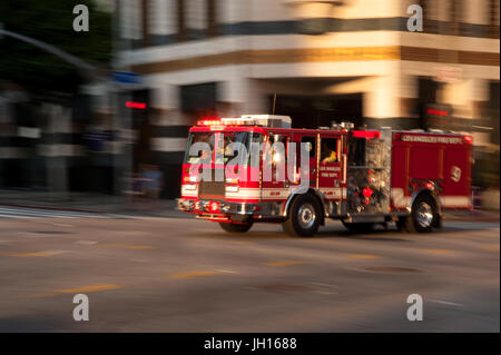 Red fire engine speeding  through the streets of Downtown Los Angeles, CA Stock Photo