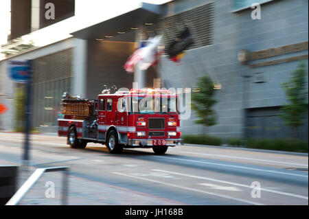 Red fire engine speeding  through the streets of Downtown Los Angeles, CA Stock Photo