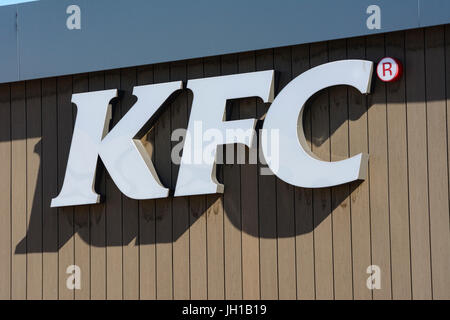 Kentucky Fried Chicken sign on the side of a KFC restaurant in Warington, Cheshire. Stock Photo