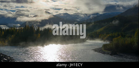 A lone fisherman has a line out in the morning mist blanketing the Russian River in south central Alaska. Stock Photo