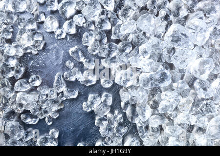 Crushed ice background. Pieces of crushed ice cubes on black background. Copy space, top view Stock Photo