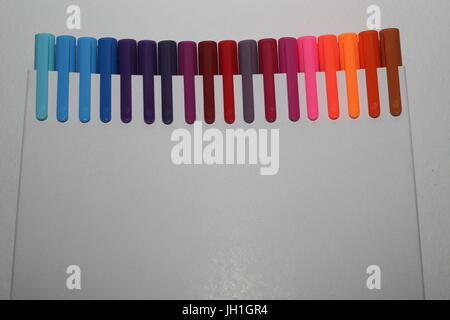 Row of pens on white background Stock Photo
