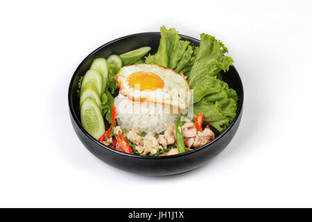 Thai popular food ,Jasmine rice topped stir - fried spicy basil with shrimp ,squid and crispy chicken and fried egg call Kao Pad Kra Prao Kai. Stock Photo