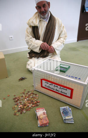 Zakat  is a form of obligatory alms-giving and religious tax in Islam. It's one of the Five Pillars of Islam.  France. Stock Photo
