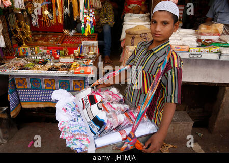 Boy selling islamic skullcaps outside Ajmer Sharif dargah, Rajasthan.  India. Stock Photo
