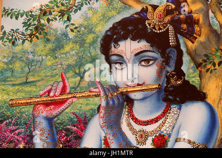 Painting depicting Hindu god Krishna playing a flute outdoors. India. Stock Photo