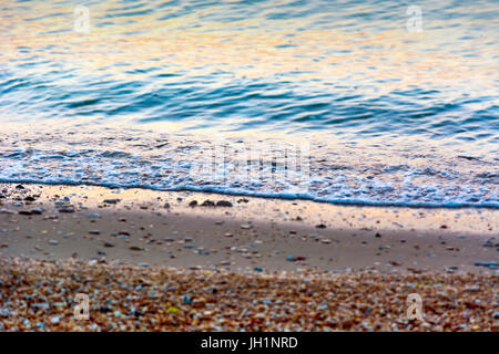 sea wave on the beach at sunset time Stock Photo