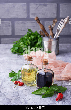 Olive oil and vinegar in glass bottles. Selective focus Stock Photo