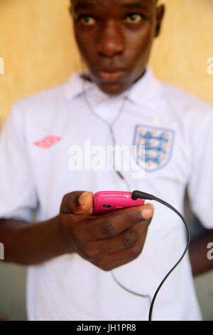 African boy using a smart phone.     Lome. Togo. Stock Photo