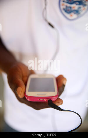African boy using a smart phone.     Lome. Togo. Stock Photo