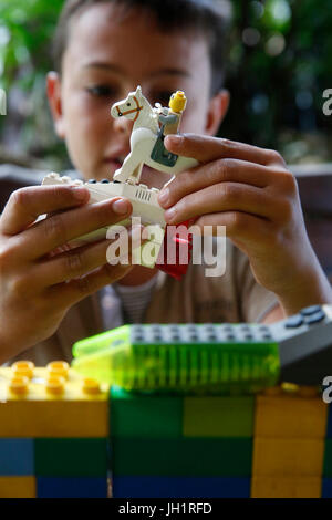 10-year-old boy playing with lego. Thailand. Stock Photo