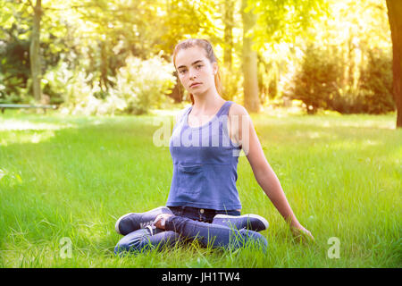 portrait of a young woman making yoga in the nature Stock Photo