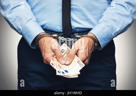 corruption and bribery concept - arrested official with money in hands Stock Photo