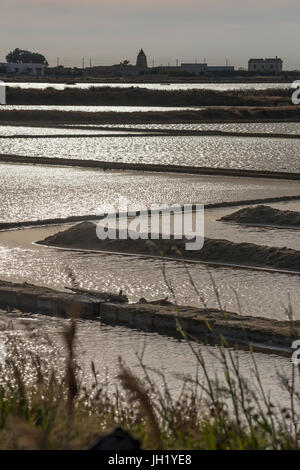 Sunlight reflecting on saltpans at the wildlife  Reserve near Nubia, south of  Trapani, on the west coast of Sicily, Italy. Stock Photo