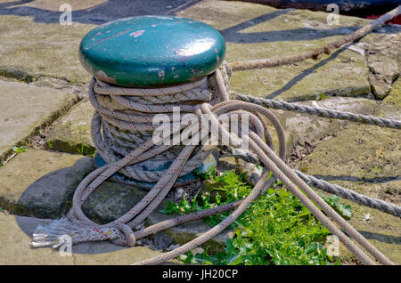 Mooring post with ropes on canal banking at hebden bridge, yorkshire Stock Photo