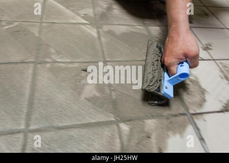 application of a tile grout by a master