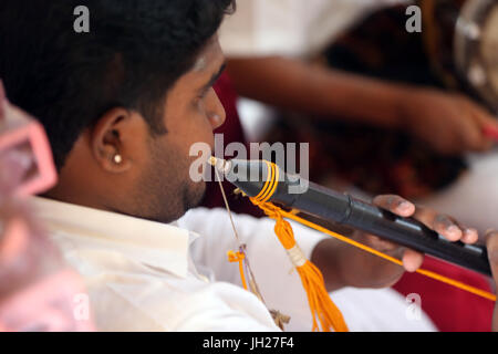 Musician Playing Flute During a Traditional Hindu Ceremony.  Sri Mariamman Hindu temple.  Singapore. Stock Photo