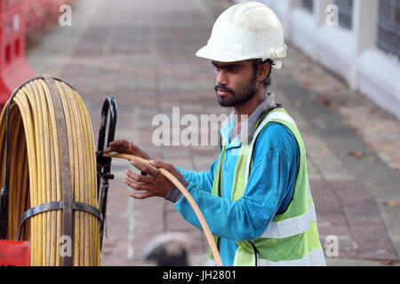 Worker on construction site.  Singapore. Stock Photo