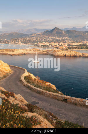 A sail boat in the clear sea around the village of Ile Rousse at sunset, Balagne Region, Corsica, France, Mediterranean, Europe Stock Photo