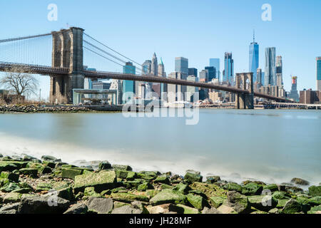 Brooklyn Bridge and Lower Manhattan skyline viewed from Brooklyn side of East River, New York City, United States of America Stock Photo