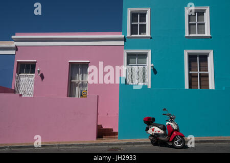 Brightly coloured houses with painted scooter in front, Waal Street in Bo-Kaap, the Malaysian and Muslim area, Cape Town Stock Photo