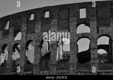 Partial view of The Colosseum. It is an oval amphitheater in the city of Rome, Italy. It is built of concrete and sand & is the largest amphitheater. Stock Photo