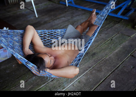 Man sleeping in a Hammock.  Vietnam. Stock Photo
