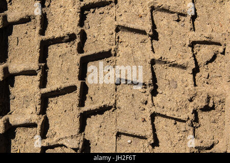 Heavy trucks tyre tracks in sandy surface, transportation background Stock Photo