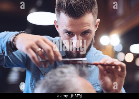 Nice bearded barber doing his job Stock Photo