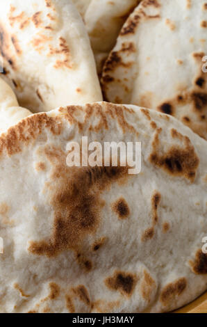 Close of up of a bowl of whole pitta breads. Stock Photo