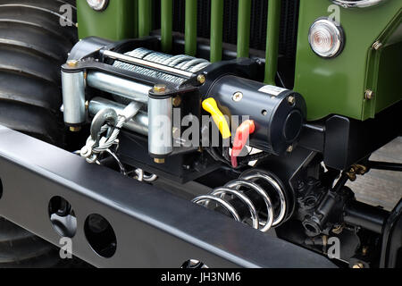 Powerful winch mounted on front of utility vehicle. Stock Photo