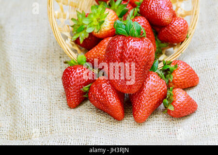 Fresh strawberries on old wooden background Strawberries in the basket Stock Photo