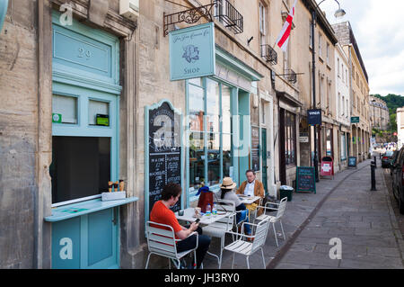 The Fine Cheese Co Company shop in Walcot Street, Bath, Somerset, England, UK. People sit at pavement tables outside in front. Stock Photo